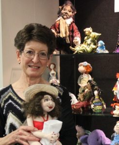 Eve amid a variety of dolls