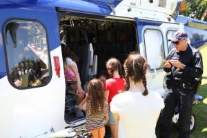 Crowd gathers as the Victoria Police Air Wing lands in Healesville