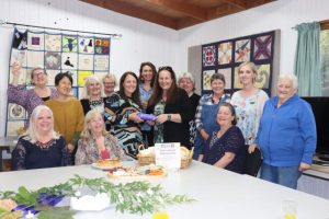 Tummies and hearts full at women’s potluck