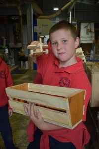 Badger Creek kids riveted by woodwork.
